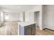 Modern kitchen island with white countertop and gray cabinets at 13332 E 110Th Way, Commerce City, CO 80022