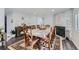 Dining room features a wood table with seating for six, a fireplace, and a decorative rug at 109 Wooster Dr, Firestone, CO 80520