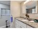 Bathroom features a granite vanity, large mirror, and a modern feel at 109 Wooster Dr, Firestone, CO 80520