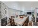 Bright dining room with seating for six, view into the living room, and a fireplace at 109 Wooster Dr, Firestone, CO 80520