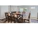 Dining area with a wood table, six chairs, and a fireplace with a decorative brick wall at 109 Wooster Dr, Firestone, CO 80520