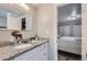Bathroom with granite countertop, sink, and view of bedroom at 109 Wooster Dr, Firestone, CO 80520