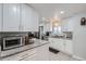 Modern kitchen with white cabinets and granite countertops at 109 Wooster Dr, Firestone, CO 80520