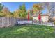 Spacious backyard with patio, fire pit, and lush lawn at 109 Wooster Dr, Firestone, CO 80520