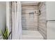 Updated bathroom with tile surround, shower, and bathtub at 109 Wooster Dr, Firestone, CO 80520