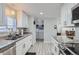 Bright kitchen with granite countertops, stainless steel appliances, and a laundry area at 109 Wooster Dr, Firestone, CO 80520