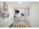 Bright entryway with bench, coat rack, and view to the kitchen at 3070 N Glencoe St, Denver, CO 80207