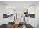 Modern kitchen with white cabinets, stainless steel appliances, and a large island at 3070 N Glencoe St, Denver, CO 80207