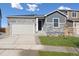 Modern home exterior with stone accents and a two-car garage at 4551 Boone Cir, Brighton, CO 80601