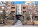 Brick building exterior with walkway and wrought iron fence at 1623 Saint Paul St # 410, Denver, CO 80206