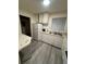 White cabinets and vinyl flooring in kitchen at 3577 S Pennsylvania St, Englewood, CO 80113