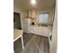White kitchen with vinyl flooring at 3577 S Pennsylvania St, Englewood, CO 80113