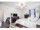 Bright bedroom featuring a king-size bed, dresser, and TV at 24747 E Calhoun Pl # C, Aurora, CO 80016