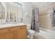 Neat bathroom with a bathtub, toilet, and wood vanity at 7160 S Wenatchee Way # F, Aurora, CO 80016