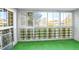 Sunroom with artificial turf flooring and ample windows at 9340 E Center Ave # 8B, Denver, CO 80247