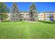 Front view of a two-story apartment building with a well-maintained lawn at 9340 E Center Ave # 8B, Denver, CO 80247