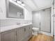 Updated bathroom with gray vanity, a large mirror, and a shower at 9340 E Center Ave # 8B, Denver, CO 80247
