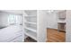 White shelves in a kitchen pantry offering ample storage at 9340 E Center Ave # 8B, Denver, CO 80247