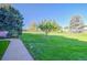 Landscaped grounds with a walkway, lush grass, and trees at 9340 E Center Ave # 8B, Denver, CO 80247