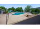 Inviting community pool with lounge chairs and umbrellas at 9340 E Center Ave # 8B, Denver, CO 80247