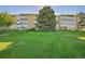 Building exterior showcasing a well-maintained lawn at 9340 E Center Ave # 8B, Denver, CO 80247