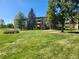 Side view of a two-story apartment building with landscaping and a walkway at 9340 E Center Ave # 8B, Denver, CO 80247