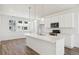 Modern kitchen with white cabinets, island, and stainless steel appliances at 6854 Merseyside Ln, Castle Pines, CO 80108