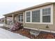 Side of house showing exterior, landscaping and snow at 7426 E 148Th Pl, Thornton, CO 80602