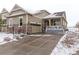 Beautiful two-story home with a snow covered front yard at 7426 E 148Th Pl, Thornton, CO 80602