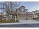 Two-story house with a two-car garage, basketball hoop, and well-maintained landscaping at 12902 W 84Th Pl, Arvada, CO 80005