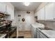 Galley kitchen with white cabinets, and in-unit laundry at 8051 Wolff St # C, Westminster, CO 80031