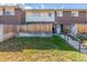 Front view of townhouse with steps and wooden fence at 8051 Wolff St # C, Westminster, CO 80031