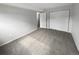 Spacious bedroom with neutral carpeting and double closets at 6800 E Tennessee Ave # 232, Denver, CO 80224