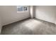 Simple bedroom with grey carpet and white brick wall at 6800 E Tennessee Ave # 232, Denver, CO 80224