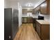 Modern kitchen featuring stainless steel appliances and light wood cabinets at 6800 E Tennessee Ave # 232, Denver, CO 80224