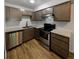Modern kitchen with stainless steel appliances and light wood cabinets at 6800 E Tennessee Ave # 232, Denver, CO 80224