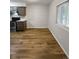 Simple dining area with wood flooring and white brick wall at 6800 E Tennessee Ave # 232, Denver, CO 80224