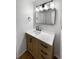 Updated bathroom with a vanity, mirror, and light wood cabinets at 6800 E Tennessee Ave # 232, Denver, CO 80224