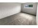 Bright bedroom showcasing a white brick accent wall and neutral carpet at 6800 E Tennessee Ave # 232, Denver, CO 80224