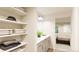Bathroom with double vanity, linen shelves and shower at , Aurora, CO 80019