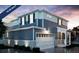 Two-story home with blue siding, white trim, and a two-car garage at , Aurora, CO 80019