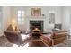 Cozy living room with fireplace, hardwood floors and two armchairs at 301 Fairfax St, Denver, CO 80220