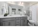 Bathroom with double vanity and gray cabinets at 5957 N Orleans St, Aurora, CO 80019