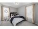 Well-lit bedroom with double bed and window curtains at 5957 N Orleans St, Aurora, CO 80019