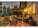 Relaxing deck with wicker furniture, colorful rug, and umbrella at 3420 Box Elder, Evergreen, CO 80439