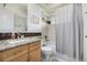 Updated bathroom with granite countertop, tub shower combo, and mosaic tile accents at 920 Home Farm Cir, Denver, CO 80234