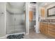 Elegant bathroom with granite vanity, tiled shower, and separate toilet area at 920 Home Farm Cir, Westminster, CO 80234