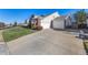 Long driveway leading to a two-car attached garage at 920 Home Farm Cir, Denver, CO 80234