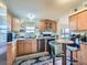 Kitchen with wood cabinets, granite countertops, and stainless steel appliances at 6195 E 83Rd Pl, Commerce City, CO 80022