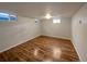 Finished basement bedroom with wood-look flooring and large windows at 123 Emerald St, Broomfield, CO 80020